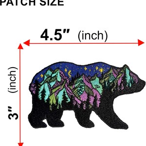 May include: An embroidered bear-shaped patch featuring a night landscape with mountains, pine trees, a crescent moon, and stars. The patch measures 4.5 inches in width and 3 inches in height, as indicated by the red measurement lines and text.