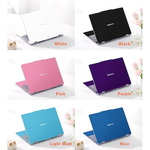 May include: A collection of six Lenovo laptops shown in white, black, pink, purple, light blue, and blue. Each laptop features a solid-colored protective skin on the lid with the Lenovo logo centered, and a visible keyboard and hinge mechanism.