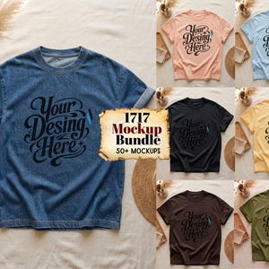 May include: A collection of short-sleeve t-shirts in various colors including denim blue, peach, light blue, black, yellow, dark brown, and olive green. Each shirt features the black text Your Desing Here with a small blue flame icon.