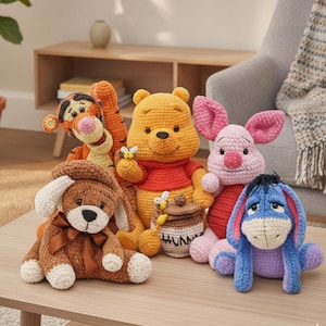 May include: A collection of five crocheted stuffed animals including a yellow bear with a red shirt holding a honey pot, an orange striped tiger, a pink pig, a blue donkey, and a brown dog with a brown ribbon bow around its neck.