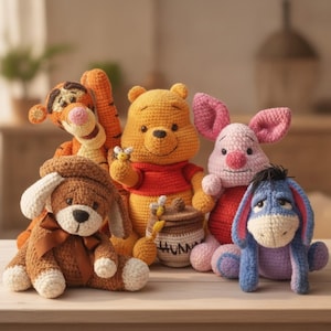 May include: A collection of five crocheted stuffed animals including a yellow bear in a red shirt holding a honey pot labeled HUNNY, an orange striped tiger, a pink pig, a blue donkey, and a brown dog with a brown ribbon around its neck.