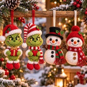 May include: Four crocheted Christmas ornaments hanging from a wooden branch. Two green creatures with grumpy expressions wear red and white hats and scarves, holding a gift and a heart. Two white snowmen wear hats and scarves with red accents.