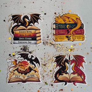 May include: Four vinyl stickers featuring fantasy dragons and books. One shows a black dragon on a stack of books titled Fourth Wing, Iron Flame, Onyx Storm, and Threshing Day. Another shows a gold dragon on books by Rebecca Yarros. Two others depict dragons with books and a sword.