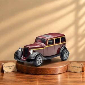 May include: A maroon and black vintage-style toy car model featuring a yellow pinstripe along the side, silver-colored headlights, and grey wheels. The vehicle has a boxy body shape with a sunroof and is displayed on a circular wooden base.