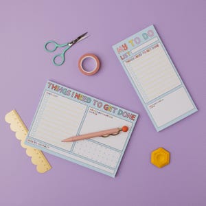 May include: Two blue to-do list notepads with colorful text. The top notepad says "My To Do List" and the bottom notepad says "Things I Need To Get Done". Both notepads have checkboxes and space for notes.