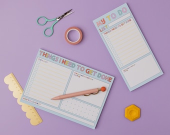 May include: Two blue to-do list notepads with colourful text. The top notepad says "My To Do List" and the bottom notepad says "Things I Need To Get Done". Both notepads have checkboxes and space for notes.