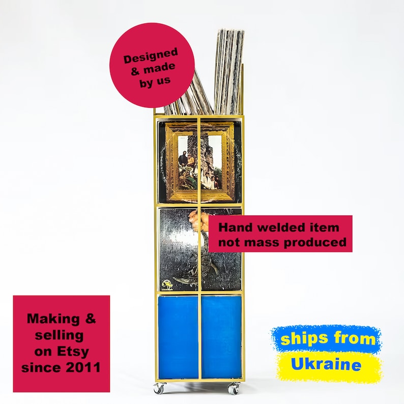 Front view of yellow four-tier metal vinyl record stand on wheels, loaded with LP albums featuring colorful covers, minimalist square steel frame
