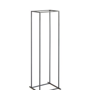 Slim tall black metal log rack with minimalist square frame, photographed on white background, modern Scandinavian indoor firewood holder design.