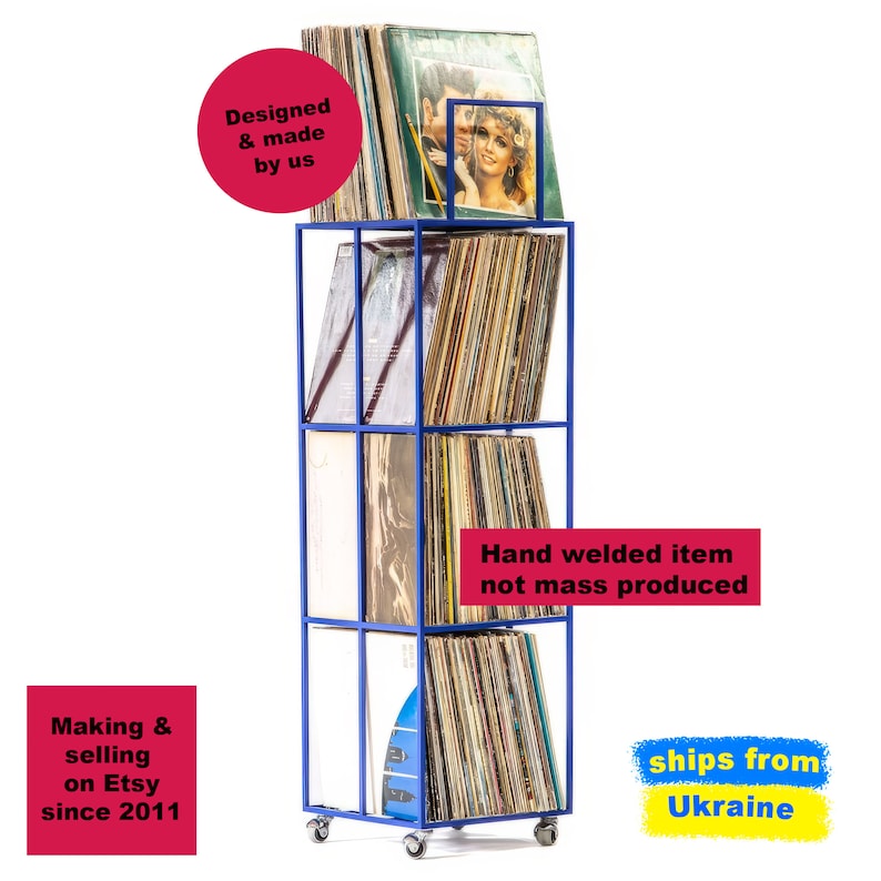 Angled view of blue four-tier metal vinyl record stand on wheels, fully loaded with LP albums, minimalist square steel frame, hand-welded in Ukraine.