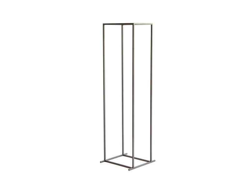 Minimalist tall black metal firewood rack frame with square base, photographed on white background, Scandinavian indoor log holder design.