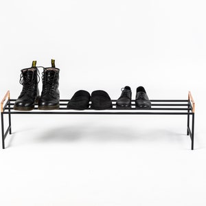Minimalist black metal shoe rack. Hand welded in Ukraine by us. Ready to use right out of the box.