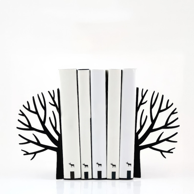 Black metal modern bookends in the minimalist style "Winter Trees. " Two halves of the tree with naked branches hold the bookends from the sides. Flat laser-cut bookends hold any number of books. Made by us in a small workshop.