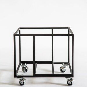 Empty black metal vinyl record cart frame with a minimalist square design, shown on four smooth-rolling caster wheels against a white background.