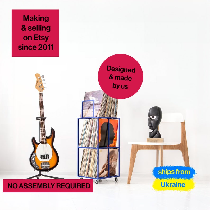 May include: Blue metal record storage unit with wheels, holding vinyl records. A black bass guitar is on a stand to the left. The text "Designed & made by us" is in a red circle. The text "ships from Ukraine" is in a yellow and blue rectangle. The text "NO ASSEMBLY REQUIRED" is at the bottom of the image.