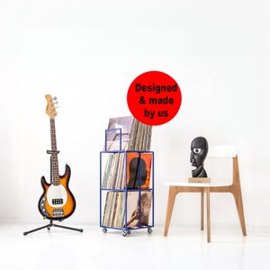 Compact three-tier metal stand on wheels for vinyl records.