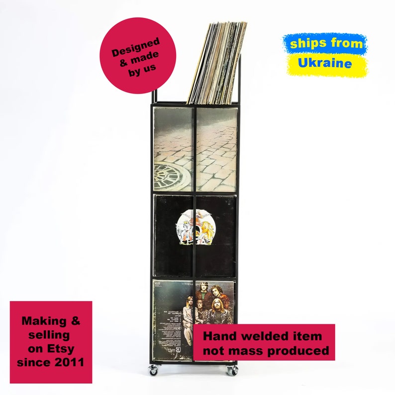 Front view of tall four-tier metal vinyl record stand on wheels, loaded with LP albums, minimalist square steel frame, handmade and hand-welded in Ukraine.