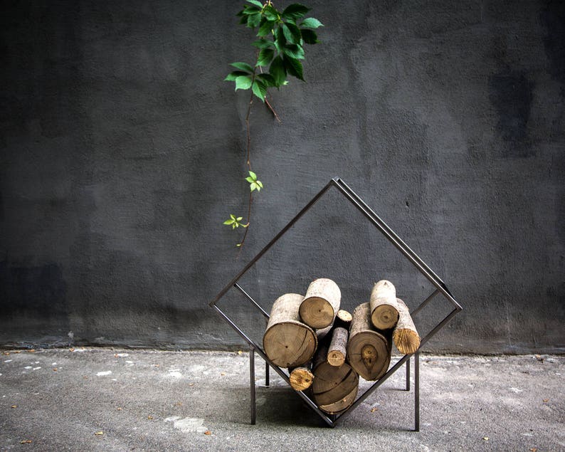 Minimalist firewood rack for modern home. Hand welded in Ukraine. Transparent finish underlines the beauty of the hand polished welding joints.