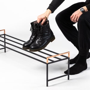 Minimalist shoe rack with stunning copper handles. Hand welded from high grade steel square tube, light and very sturdy. Designed and made in Ukraine.