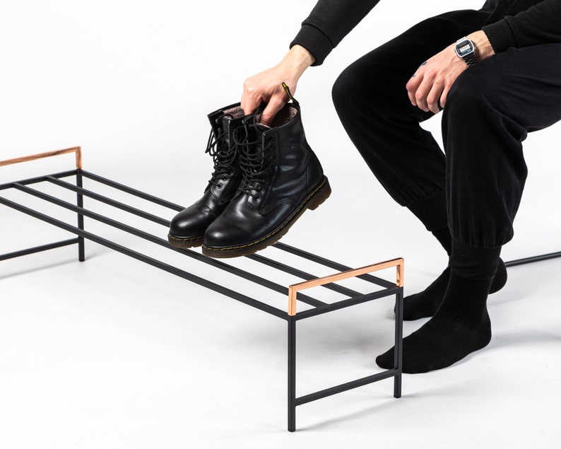 Minimalist shoe rack with stunning copper handles. Hand welded from high grade steel square tube, light and very sturdy. Designed and made in Ukraine.