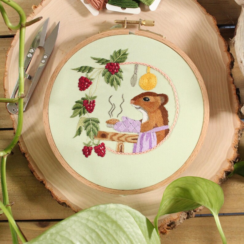 embroidery of a mouse baking a pie in it's home