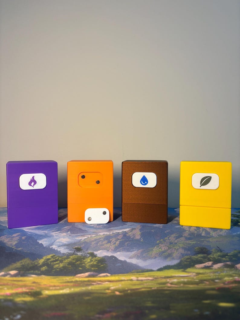 May include: Four rectangular storage boxes in purple, orange, brown, and yellow. The purple box features a white icon of a flame, the brown box a blue water drop, and the yellow box a leaf. The orange box has a small white rectangular piece with two dots.