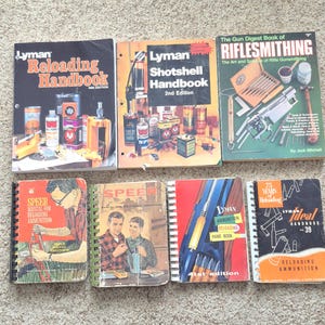 May include: A collection of seven instructional books on ammunition reloading and gunsmithing, including titles such as Lyman Reloading Handbook, Lyman Shotshell Handbook, The Gun Digest Book of Riflesmithing, and various Speer and Lyman manuals.
