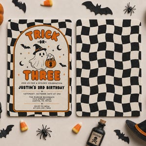 May include: A rectangular birthday invitation card featuring a black and white checkered border and a central illustration of a ghost wearing a witch hat and holding a pumpkin bucket. The text reads TRICK-OR-THREE, JUSTIN'S 3RD BIRTHDAY.