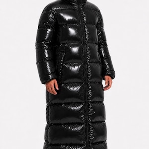May include: A long, black, shiny, quilted puffer coat with a full-length front zip and an integrated hood that covers the head and neck, featuring a small cutout opening for the eyes. The coat has a glossy finish and horizontal baffles.