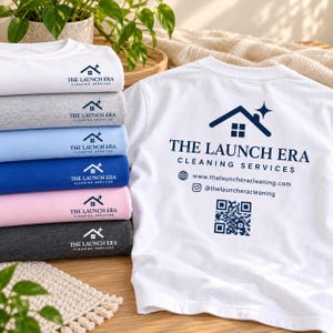 Puede incluir: Una pila de camisetas dobladas en blanco, gris, azul claro, azul real, rosa y carbón, junto a una camiseta blanca con un logotipo azul oscuro con un icono de casa, el texto THE LAUNCH ERA CLEANING SERVICES, un sitio web, Instagram y un código QR.
