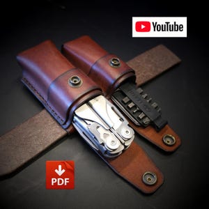 May include: Two brown leather sheaths with metal snap closures, one containing a silver multi-tool and the other holding a black bit kit. The sheaths feature stitched edges and are designed for belt carry. The image includes YouTube and PDF icons.