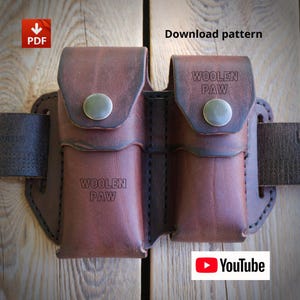 Peut inclure: Un étui de ceinture double en cuir marron avec fermeture à rabat et boutons-pression en métal. Le texte "WOOLEN PAW" est gravé sur les deux pochettes. L'article comprend un modèle de téléchargement PDF et un lien YouTube pour les instructions.