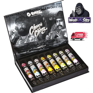May include: A black rectangular display box featuring a black and white graphic of Cheech and Chong on the interior lid. The box contains eight cylindrical tubes arranged in a row, each with colourful labels and the G-Rollz brand logo printed on them.