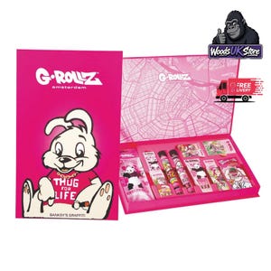 May include: A pink G-Rollz Amsterdam gift set featuring a cartoon rabbit wearing a red shirt with the text THUG FOR LIFE. The open box reveals various smoking accessories including rolling papers, cones, and tubes with panda and rabbit graphics.