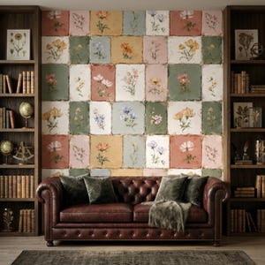 May include: A dark brown leather tufted sofa with four dark green velvet pillows and a faux fur throw, positioned against a wall covered in rectangular tiles featuring various botanical illustrations in muted tones of pink, green, and yellow.
