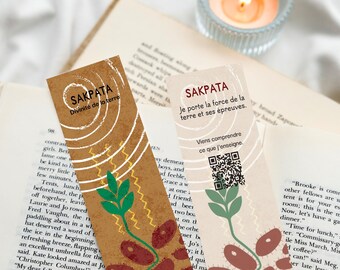 May include: Two rectangular bookmarks featuring botanical illustrations of a green sprout emerging from brown seeds. The left bookmark is brown with white concentric circles and the text SAKPATA Divinité de la terre. The right is cream with a QR code and THÉSIS.