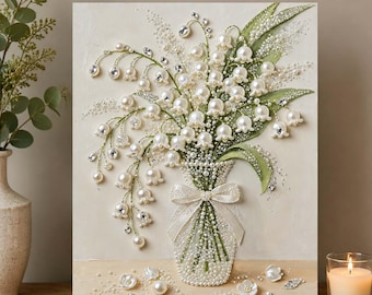May include: A rectangular wall art piece featuring a textured cream background with a three-dimensional arrangement of lily of the valley flowers. The flowers are crafted from white pearls and clear crystals, accented by green leaves and a white ribbon.
