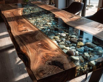 May include: A rectangular dining table featuring two thick, natural-edge walnut wood slabs on the sides with a central channel filled with smooth, multi-colored river stones encased in a clear, transparent resin surface.
