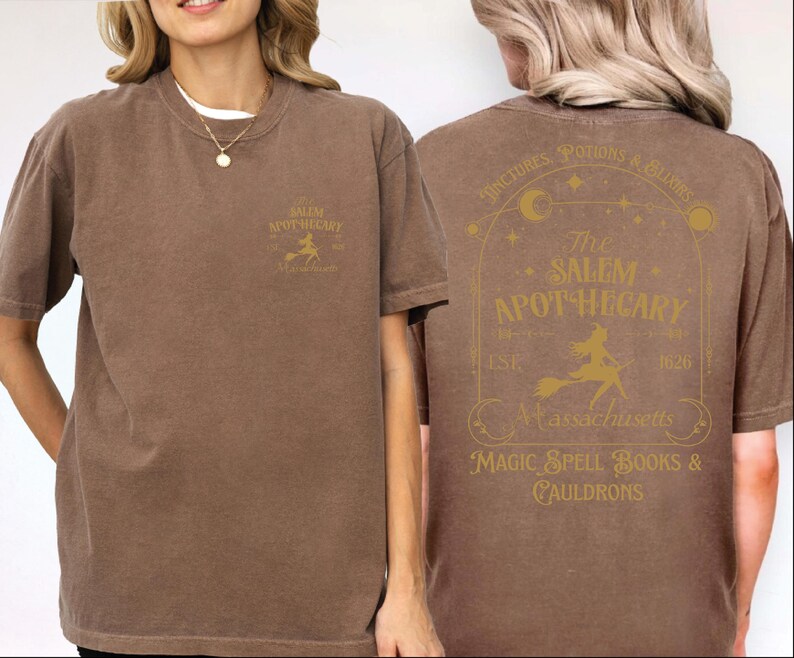A woman wearing a brown t-shirt with text and graphics related to Salem Apothecary.