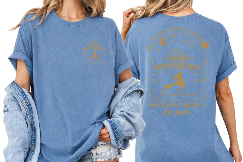 two women wearing blue t-shirts with gold text and graphics on the back.