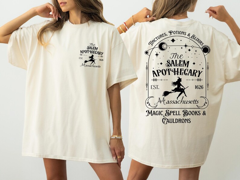 a woman wearing a white t-shirt with text and graphics related to a witch-themed business.