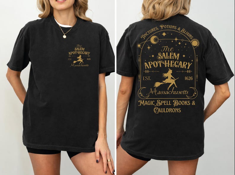 a woman wearing a black t-shirt with a graphic design on the back. The design includes text and a depiction of a witch on a broomstick.