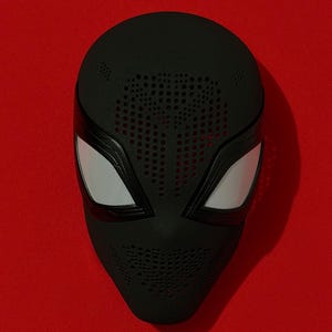 May include: A black full-face mask featuring a textured surface with numerous small circular perforations across the forehead and chin areas. The mask includes two large, angular eye openings covered with a white mesh material and black frames.