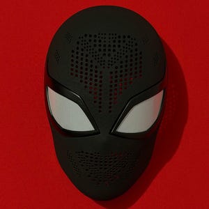 May include: A matte black full-face mask featuring a textured surface with perforated detailing across the forehead and mouth area. The mask includes two large, almond-shaped eye openings covered with a fine, light gray mesh material.