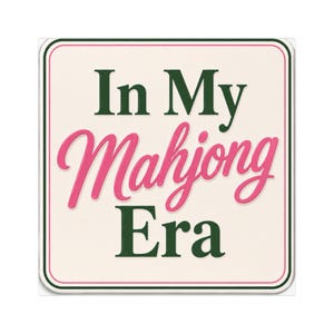 May include: A square sign with a cream-colored background and rounded corners. The text In My Mahjong Era is printed in the center. The words In My and Era are in dark green serif font, while Mahjong is in a pink cursive script font.