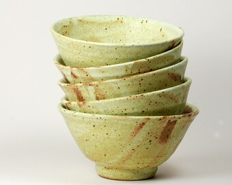 Stoneware soup bowls glazed in matte yellow glaze with kaki decoration inside each one