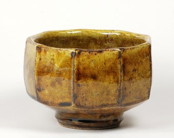 Faceted stoneware serving bowl in amber glaze over a crackle slip