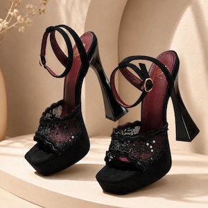 May include: A pair of black platform high-heeled sandals featuring a square toe, a thick flared heel, and an ankle strap with a gold buckle. The upper part of the shoe is crafted from black lace with subtle sequin accents, and the insole is dark red.