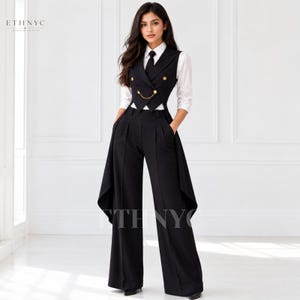 May include: A black double-breasted vest with gold buttons and a gold chain detail, worn over a white long-sleeved collared shirt with a black tie. The outfit includes high-waisted black wide-leg trousers with long side panels. Text reads ETHNYC.