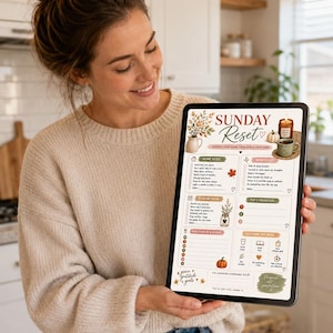 May include: A digital tablet displaying a Sunday Reset planner template with sections for home tasks, mind reset, weekly planning, top priorities, meal planning, and self-care. The design features autumn-themed illustrations of leaves, a pumpkin, a candle, and a mug.