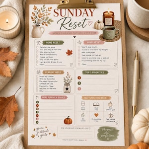 May include: A Sunday Reset checklist printed on paper and held by a brown clipboard. The document features sections for home and mind tasks, weekly planning, meal planning, and self-care, decorated with autumn-themed illustrations of leaves and pumpkins.